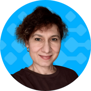 Consultant portrait of Guliya with a friendly expression, set against a blue background featuring abstract shapes, representing the dedicated team at Bursting Silver specializing in iMIS software solutions.