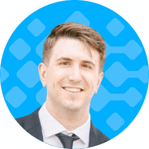 Christopher Sparling, Consultant at Bursting Silver, smiling in a professional suit against a blue geometric background, representing the company's expertise in iMIS software solutions.