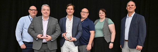 iNNOVATIONS 2025 Awards Group of professionals at ASI iNNOVATIONS Conference holding awards, celebrating achievements in AI and membership organization solutions.