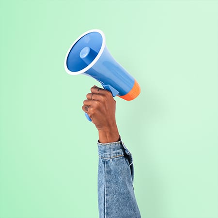Hand holding megaphone marketing announcement campaign